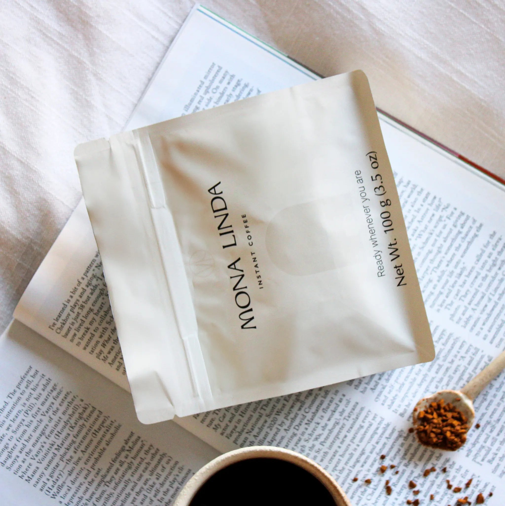 Mona Linda instant coffee in a peaceful setting with an open book