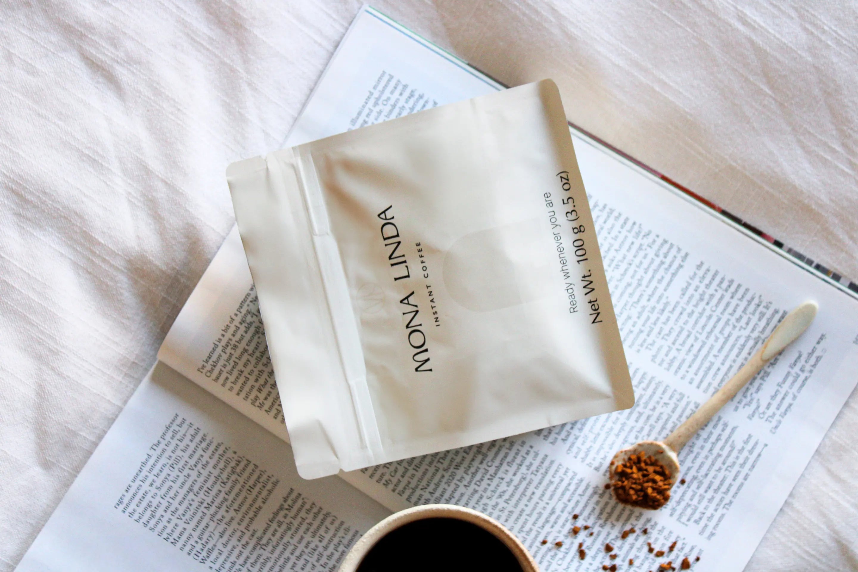 Mona Linda instant coffee in a peaceful setting with an open book