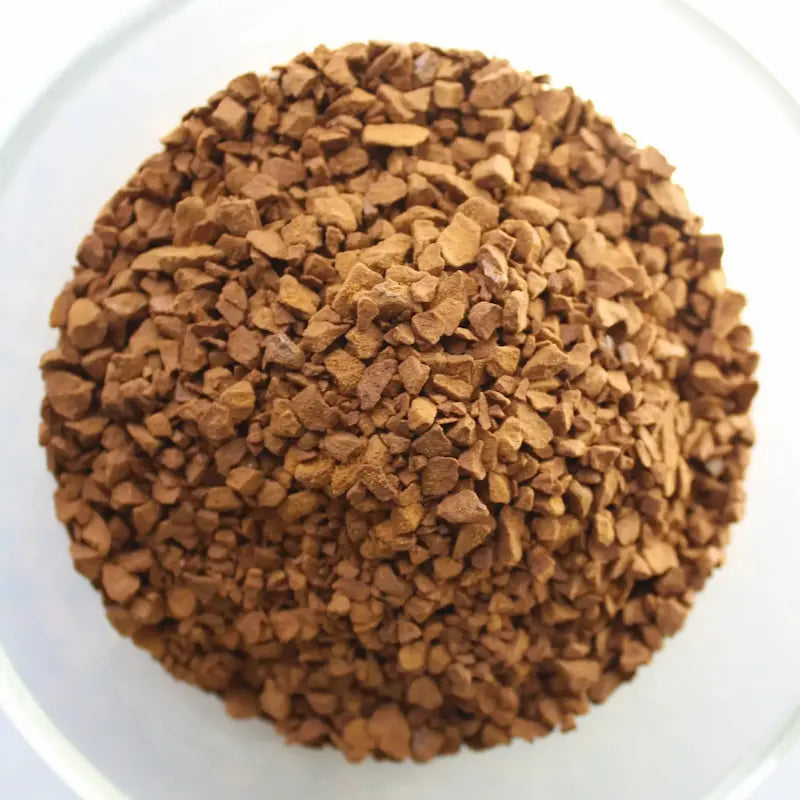 Freeze-dried coffee in a glass bowl, showcasing the best soluble coffee for a nice instant coffee experience.