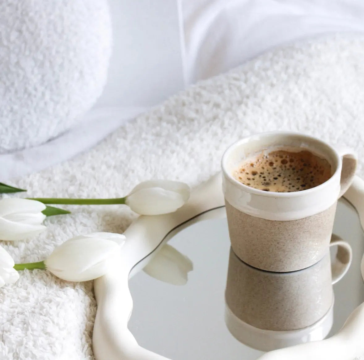 Quality instant coffee—for a moment of reflection on a comfy blanket with the soft touch of white tulips.